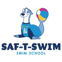 Cartoon sea lion mascot wearing a blue shirt with number 84, holding a beach ball next to the SAF-T-SWIM logo.